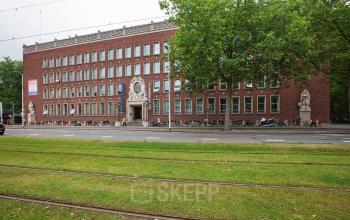 Exterior view of an office building located at Schiekade 830, Rotterdam Center, featuring a classic brick facade and large windows ideal for potential office space rental.