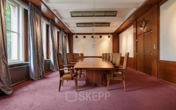 Elegant office space rental at Schiekade 830, Rotterdam Center, featuring a large wooden conference table and classic decor.