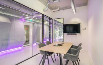 Modern office space rental at Vasteland 42-110, Rotterdam, with stylish furnishings and vibrant lighting accents.