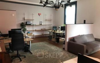 Interior of office space at Schiekade 105 in Rotterdam Center with desks, chairs, computers, and shelving units.