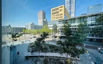 Exterior view of a modern office complex at Kruisplein 480, Rotterdam Center, showcasing urban surroundings and nearby public space, ideal for office space rental.