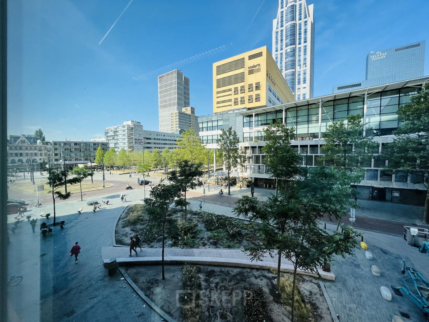 Exterior view of a modern office complex at Kruisplein 480, Rotterdam Center, showcasing urban surroundings and nearby public space, ideal for office space rental.