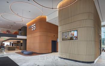 Modern office lobby at Blaak 555, Rotterdam Center with wooden accents and LED lighting, ideal for rent office space.
