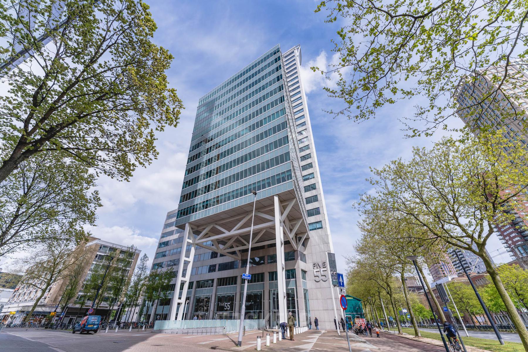 A modern high-rise office building located at Blaak 555 in Rotterdam Center, ideal for those seeking office space rental in the city.