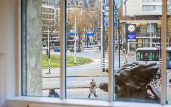 View of Weena 87 in Rotterdam Center, showcasing nearby roads and urban landscape through a large window.