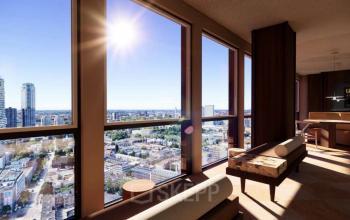 Panoramic view from a modern office space at Coolsingel 139, Rotterdam Center, showcasing large windows and elegant furnishings, ideal for office space rental, with vibrant cityscape seen outside.