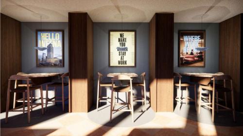 Chic lounge area at Coolsingel 139, Rotterdam Center, featuring stylish seating and framed motivational posters, ideal for office space rental.