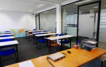 Office space for rent at Wijnhaven 76 in Rotterdam Center with desks and chairs, ideal for workspace rental.