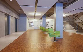 Spacious and well-lit office space rental at Westblaak 92, Rotterdam Center with modern green chairs and a welcoming ambience.