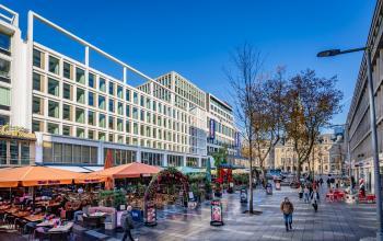 View of Stadhuisplein 9-23 in Rotterdam Center, showing a bustling outdoor scene with nearby office spaces to rent.