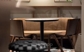 Stylish office space with a cozy seating area featuring modern chairs and artwork. Ideal for office space rental.