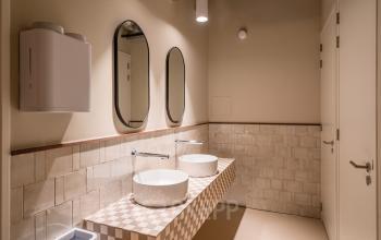 Modern restroom at Stadhuisplein 9-23 in Rotterdam Center, featuring chic tile design, offering a sleek addition to office space rental options.
