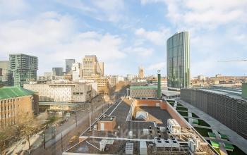 View from an office located at Coolsingel 104, overlooking the skyline of Rotterdam Center, highlighting the vibrant urban setting.