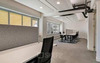 Modern office space in Rotterdam Center at Coolsingel 104, featuring natural light and furniture, ideal for office space rental.