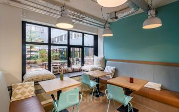 Stylish lounge area in the office space rental at Westblaak 180, Rotterdam Center, Rotterdam, featuring modern seating and large windows.