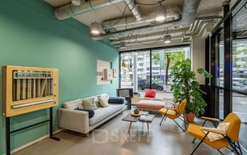 Modern lounge area with cozy seating and vibrant decor at Westblaak 180 in Rotterdam Center, ideal for office space rental.