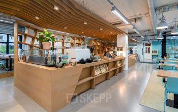 Modern office space rental at Westblaak 180, Rotterdam Center featuring a contemporary pantry with wooden accents and various seating areas.