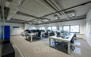 Spacious office to rent at Westblaak 180, Rotterdam Center, featuring multiple workstations with chairs, computers, and ample natural light.
