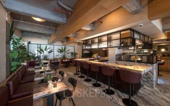 Modern furnished workspace in Beursplein 37, Rotterdam Center with stylish seating areas and a central bar.