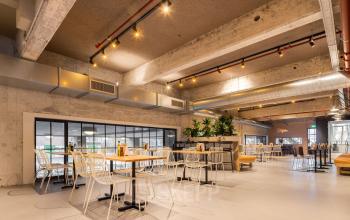 Spacious and modern office space rental at Beursplein 37 in Rotterdam Center, with industrial design elements and ample seating.