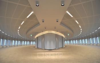 Spacious, empty office to rent at Beursplein 37, Rotterdam Center, featuring modern ceiling design and full-length windows along curved walls.