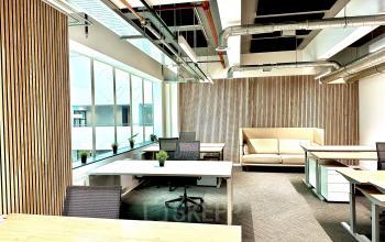 Modern office space rental at Beursplein 37, Rotterdam Center, featuring sleek furnishings, large windows, and natural wood accents.