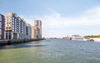 Exterior view of modern office buildings along the waterfront in Rotterdam Delfshaven at Lloydstraat 21 B, ideal for anyone looking to rent office space with a desirable location.