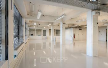 Spacious interior office space with polished floors and large windows at Lloydstraat 21 B in Rotterdam Delfshaven, available for office space rental.