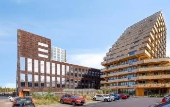 Exterior view of the office buildings at Kratonkade 7-27, Rotterdam Delfshaven, showcasing a modern structure with unique architecture, ideal for office space rental.