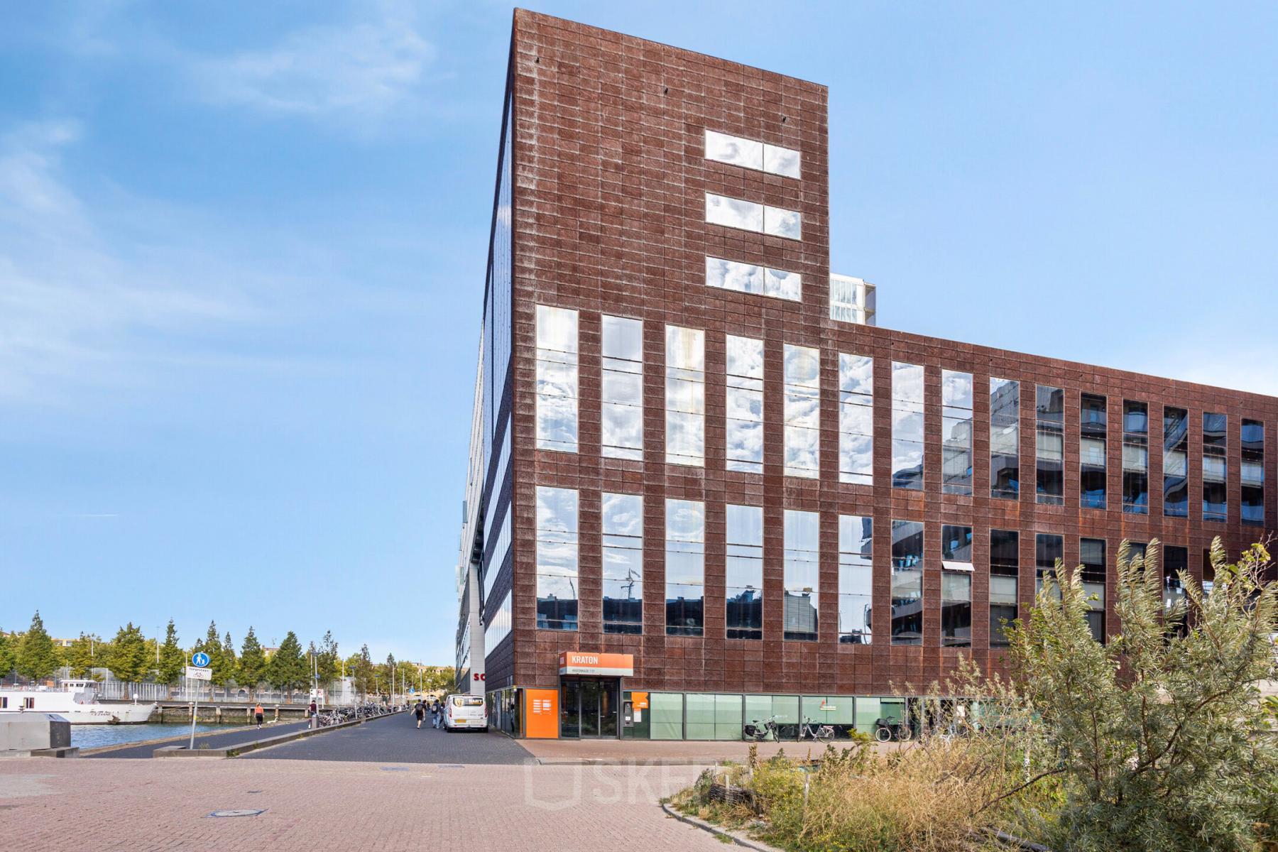 Exterior view of an office building at Kratonkade 7 - 27 in Rotterdam Delfshaven, highlighting modern architecture. Ideal office space rental for businesses looking to rent office space in a prime location.