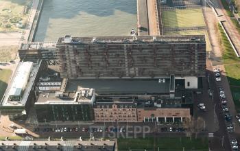 Aerial view of a large, modern office building at Lloydstraat 5, Rotterdam Delfshaven, offering opportunities for office space rental.