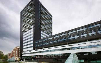 Modern office building at Westerlaan 10-65, Rotterdam Delfshaven, featuring a high-rise structure with large windows.