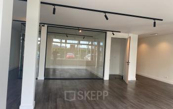 Spacious office with modern glass partitions and sleek flooring, located at Haringvliet 76, Rotterdam, ideal for office space rental, offering an open and flexible environment for productive work.