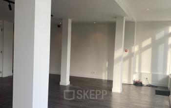 Interior space at Haringvliet 76, Rotterdam, featuring wooden floors and white walls, suitable for office space rental opportunities.