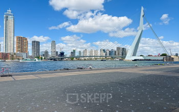 View of Rotterdam's skyline and Erasmus Bridge from Wilhelminakade 173, ideal for enterprises seeking office space rental with inspiring surroundings.