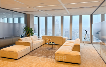 Spacious and modern lounge area in an office to rent at Wilhelminakade 173, Rotterdam Kop van Zuid, featuring comfortable seating and a city view, ideal for office space rental.