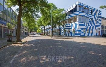 Exterior view of an office building with striking blue and white geometric patterns located at Zomerhofstraat 71, Rotterdam North, ideal for office space rental.