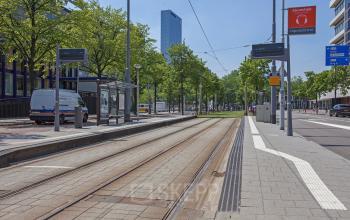 View of Zomerhofstraat 71, Rotterdam North, featuring a tram track, trees, and nearby office buildings.