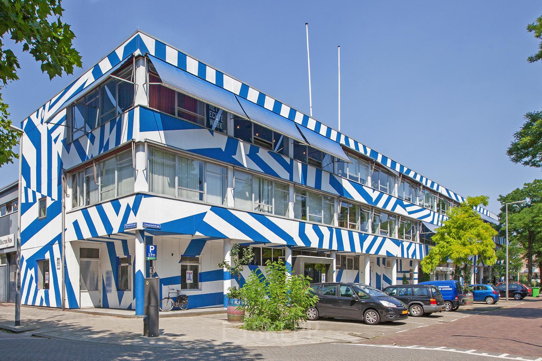 Exterior view of the blue and white striped office building located at Zomerhofstraat 71, Rotterdam North, suitable for office space rental.
