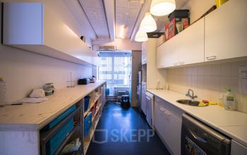 A compact pantry area with countertops and overhead storage at Zomerhofstraat 84, Rotterdam North, perfect for office space rental.