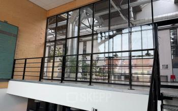 Modern office interior at Scheepsbouwweg 29, Rotterdam Waalhaven, featuring industrial design elements and glass partitions ideal for office space rental.