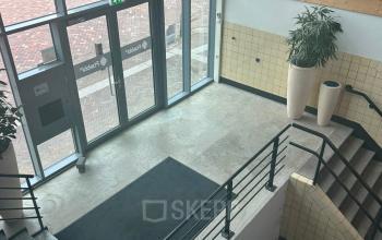 Empty office entrance area at Scheepsbouwweg 29, Rotterdam Waalhaven, featuring modern design elements suitable for office space rental.