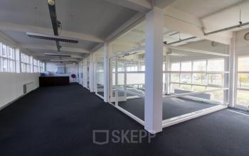 Empty office space with glass partition walls located at Overschieseweg 34, Schiedam.