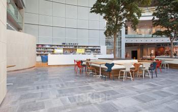Spacious and well-lit office space rental at Evert van de Beekstraat 104, Schiphol with a modern library and colorful chairs.