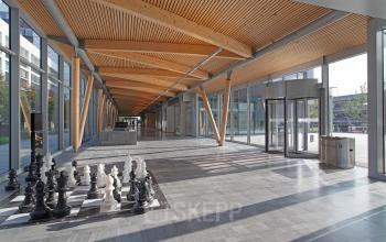 Spacious and well-lit entrance of office space rental at Evert van de Beekstraat 104, Schiphol, featuring a large chess set and modern design.