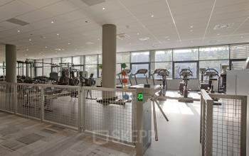 Modern fitness center within the office space rental at Evert van de Beekstraat 104, Schiphol, equipped with various exercise machines.