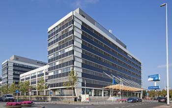 Modern office building at Evert van de Beekstraat 104 in Schiphol, ideal for office space rental with a sleek facade and landscaped surroundings.
