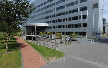 Exterior view of office building at Evert van de Beekstraat 310, Schiphol Airport, Schiphol with paved walkway and landscaped surroundings. Office space rental opportunities available.