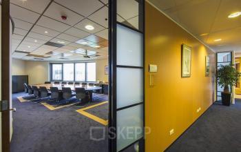 Spacious conference_room at Evert van de Beekstraat 310 with a large table and chairs, ideal for a productive office space rental in Schiphol.