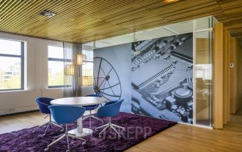 Modern furnished conference room with round table and blue chairs at Boeingavenue 223 – 239, Schiphol Rijk, Schiphol, available for office space rental.